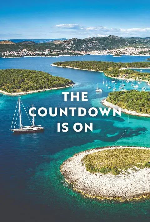 Pakleni Islands archipelago in the turquoise Adriatic Sea near Hvar, Croatia with several sailboats in the bay. Text overlay reads: "The countdown is on".