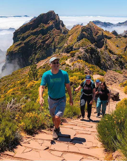 Hikers on the ridge trail between Pico do Arieiro and Pico Ruivo on the island of Madeira, Portugal.