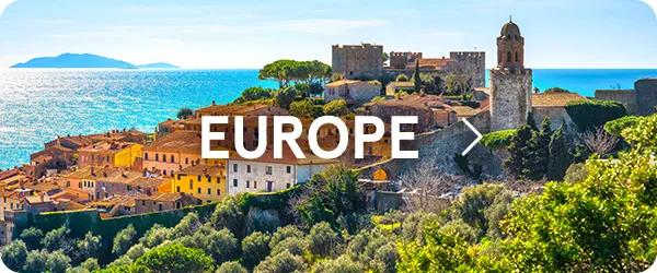 Panoramic view of a historic European coastal town with terracotta-roofed buildings, ancient stone walls, and a prominent tower overlook a vibrant blue sea under a clear sunny sky, with the word "EUROPE" displayed in white text in the center.