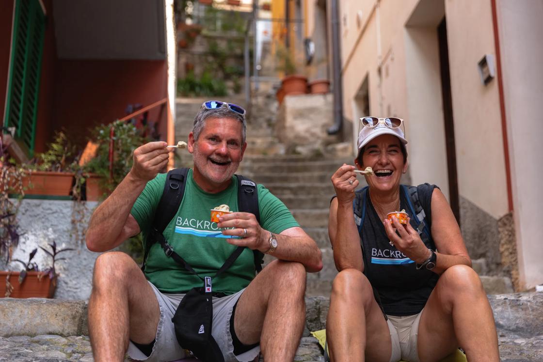 Two Backroads guests take a well-deserved break to enjoy some gelato in Bellagio.