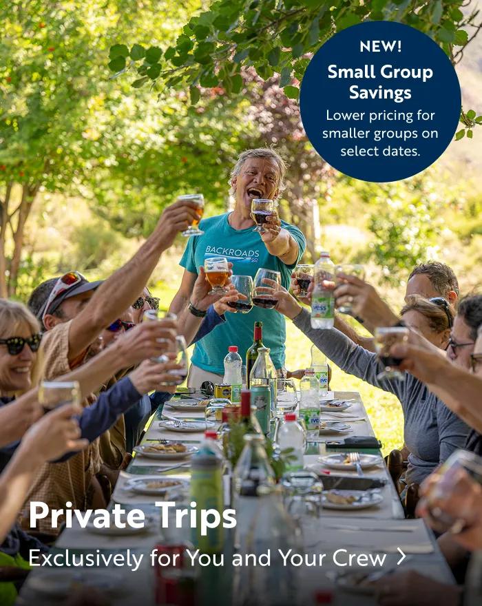 A group of guests toast and cheers with wine. Text overlay reads: "Private trips, exclusively for you and your crew. New Small Group Savings - Lower pricing for smaller groups on select dates".