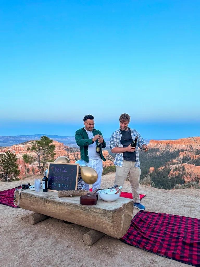 Backroads Trip Leader Ben opens champagne at the edge of Bryce Canyon.