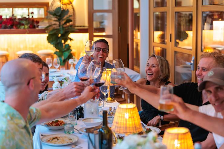 Guests on the Cyprus Bike Tour toast at the dinner table after a day of riding.