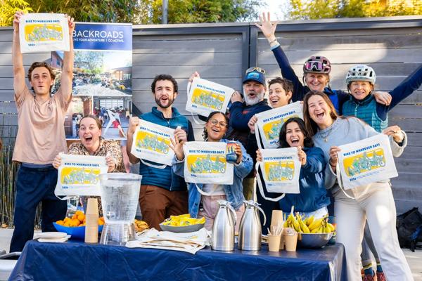 Employees at Backroads' headquarters in Berkeley, California, hosting an energizer station that featured coffee, snacks, and exclusive tote bags for the 2026 Bike to Wherever Day.