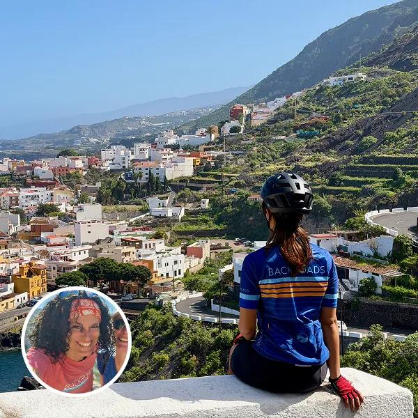 Lara Petinal Coll headshot on top of a trip photo overlooking a town from Canary Islands Bike Tour.