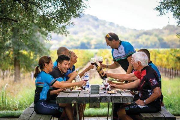 A group having a wine picnic on a Backroads cycling tour.