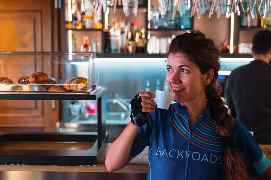 A Backroads cyclist enjoying a cafe in a coffee bar in Piedmont, Italy.