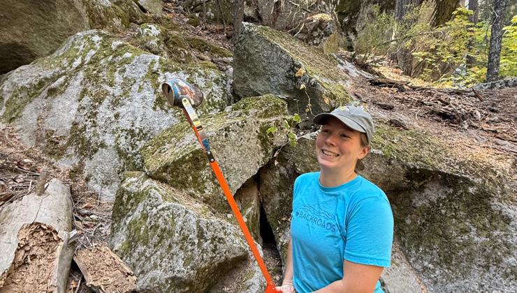 A Backroads employee picking up trash from around Mirror Lake during Yosemite FaceLift 2026.