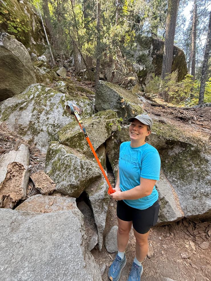 A Backroads employee picking up trash from around Mirror Lake during Yosemite FaceLift 2026.