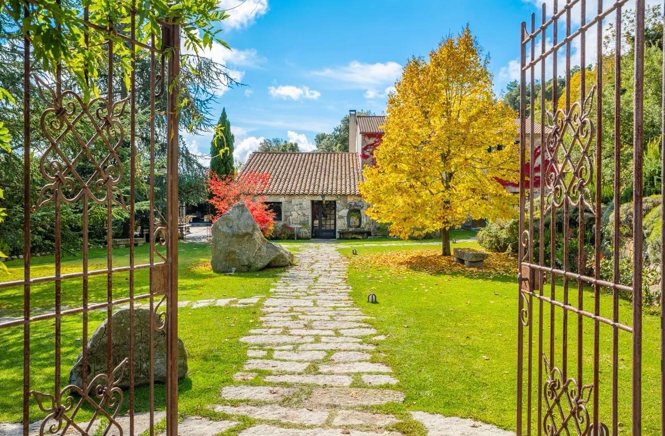 The entrance gate and stone path leading up to the A Pignata, a family-run country inn and farm restaurant located in the Alta Rocca mountains of Levie, Corsica.