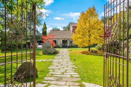 The entrance gate and stone path leading up to the A Pignata, a family-run country inn and farm restaurant located in the Alta Rocca mountains of Levie, Corsica.