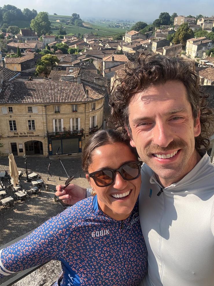 Trip Leaders Joey and Shauna with a village of France in the background.