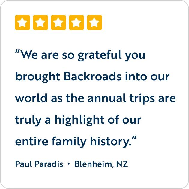 A five-star customer review graphic featuring the text quote, "We are so grateful you brought Backroads into our world as the annual trips are truly a highlight of our entire family history," attributed to Paul Paradis from Blenheim, NZ.
